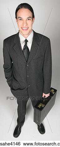 Stock Photograph - Smiling businessman holding briefcase . Fotosearch