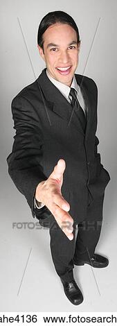 Smiling businessman in gray suit going to shake hands View Large Photo Image Stock Photograph - Smiling businessman in gray suit going to shake hands. Fotosearch