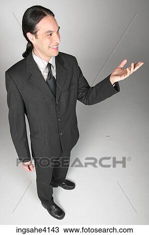 Smiling businessman in gray suit making presentation View Large Photo Image Stock Image - Smiling businessman in gray suit making presentation . Fotosearch