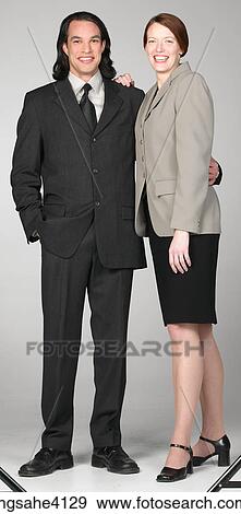 Stock Photo - Smiling businesspeople standing together . Fotosearch
