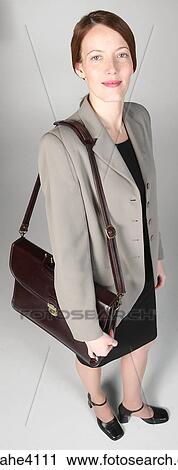 Stock Image - Smiling businesswoman carrying briefcase. Fotosearch