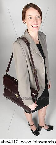 Smiling businesswoman carrying briefcase View Large Photo Image Stock Image - Smiling businesswoman carrying briefcase . Fotosearch
