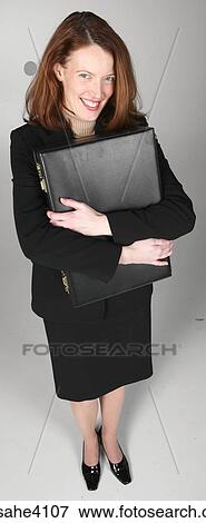 Smiling businesswoman clutching briefcase View Large Photo Image Stock Photo - Smiling businesswoman clutching briefcase. Fotosearch