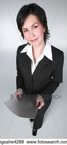 Stock Photo - Smiling businesswoman in black suit holding document. Fotosearch