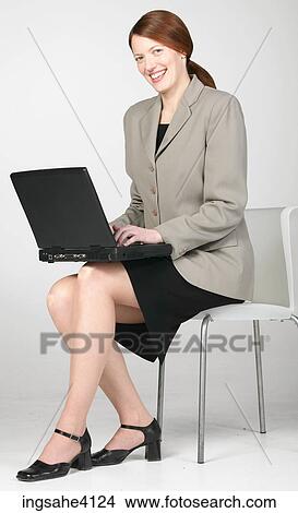 Smiling businesswoman typing on black laptop View Large Photo Image Picture - Smiling businesswoman typing on black laptop. Fotosearch