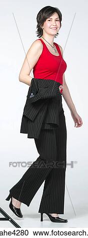 Smiling businesswoman with jacket over her arm View Large Photo Image Stock Image - Smiling businesswoman with jacket over her arm. Fotosearch