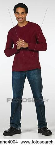 Smiling man in jeans and red sweater View Large Photo Image Picture - Smiling man in jeans and red sweater . Fotosearch