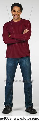 Smiling man in jeans and red sweater View Large Photo Image Stock Image - Smiling man in jeans and red sweater. Fotosearch