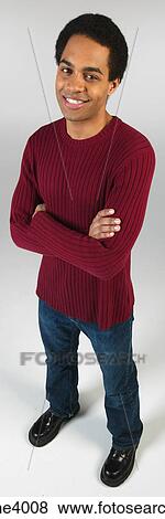 Stock Photo - Smiling man in jeans and red sweater . Fotosearch