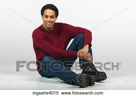 Smiling man relaxing in jeans and sweater View Large Photo Image Stock Photography - Smiling man relaxing in jeans and sweater . Fotosearch