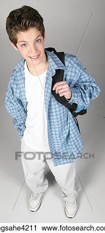 Smiling teenaged boy carrying backpack View Large Photo Image Stock Image - Smiling teenaged boy carrying backpack. Fotosearch