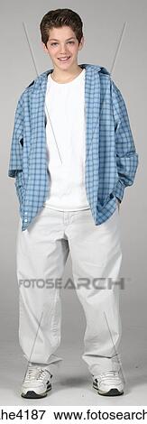 Smiling teenaged boy in white pants and blue shirt View Large Photo Image Stock Photo - Smiling teenaged boy in white pants and blue shirt. Fotosearch