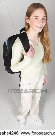 Smiling teenaged girl carrying backpack View Large Photo Image Stock Photograph - Smiling teenaged girl carrying backpack. Fotosearch