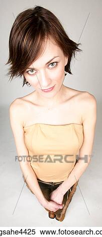 Stock Photography - Smiling woman in brown outfit. Fotosearch