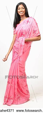 Stock Image - Smiling woman in pink sari. Fotosearch