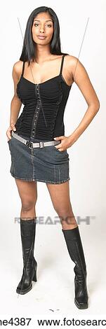 Smiling woman in skirt and black tank top View Large Photo Image Stock Photo - Smiling woman in skirt and black tank top. Fotosearch