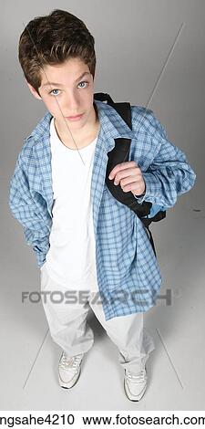 Teenaged boy in blur shirt carrying backpack View Large Photo Image Stock Image - Teenaged boy in blur shirt carrying backpack. Fotosearch