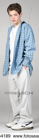 Teenaged boy in white pants and blue shirt View Large Photo Image Stock Photo - Teenaged boy in white pants and blue shirt. Fotosearch
