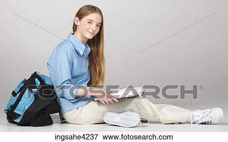 Teenaged girl studying from textbook View Large Photo Image Stock Photo - Teenaged girl studying from textbook. Fotosearch