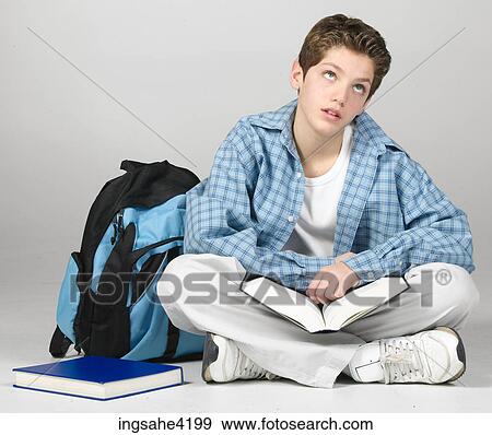 Thinking teenaged boy studying textbook View Large Photo Image Stock Photo - Thinking teenaged boy studying textbook. Fotosearch