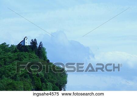 White church on tree-covered cliff in mountain range View Large Photo Image Stock Photography - White church on tree-covered cliff in mountain range . Fotosearch
