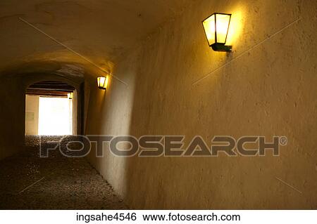 Stock Photograph - White stone hallway lit with electrical lamps . Fotosearch