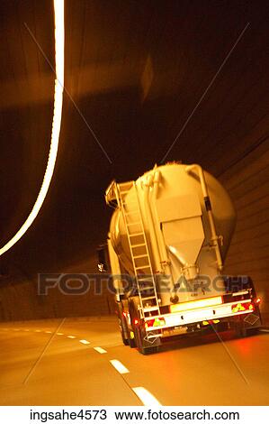 White tanker truck driving through tunnel lit with electrical lighting View Large Photo Image Stock Image - White tanker truck driving through tunnel lit with electrical lighting . Fotosearch