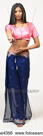 Stock Photograph - Woman belly dancing in pink and blue outfit. Fotosearch