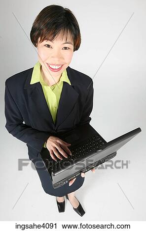 Stock Image - Woman holding a laptop . Fotosearch