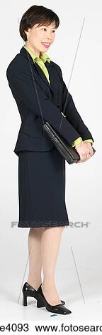 Stock Image - Woman holding a laptop . Fotosearch