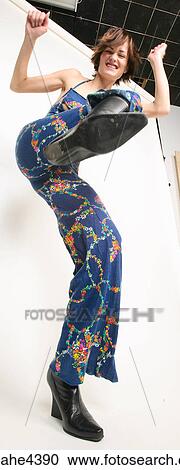 Stock Image - Woman in blue outfit kicking her foot . Fotosearch