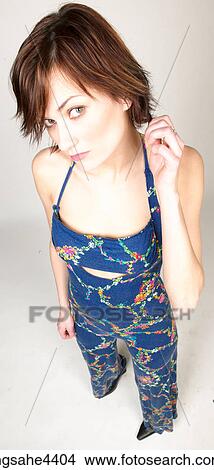 Woman in blue outfit playing with her hair View Large Photo Image Picture - Woman in blue outfit playing with her hair. Fotosearch