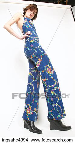 Woman in blue outfit standing with attitude View Large Photo Image Picture - Woman in blue outfit standing with attitude . Fotosearch