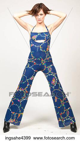 Woman in blue outfit with her hands behind her head View Large Photo Image Stock Photo - Woman in blue outfit with her hands behind her head. Fotosearch