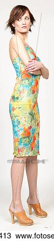 Woman in colorful floral sundress View Large Photo Image Stock Image - Woman in colorful floral sundress . Fotosearch