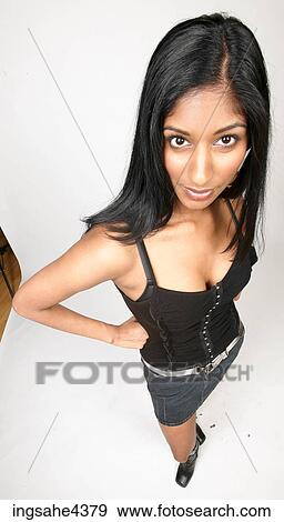 Woman in skirt and black tank top View Large Photo Image Stock Photo - Woman in skirt and black tank top . Fotosearch