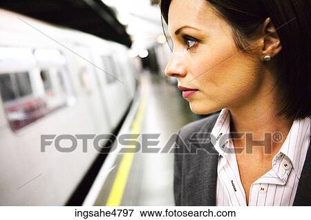 Stock Photo - Woman in train station . Fotosearch