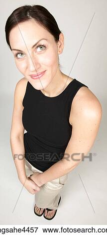 Woman smiling shyly View Large Photo Image Stock Photo - Woman smiling shyly. Fotosearch