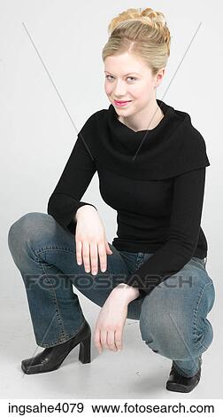 Stock Photo - Woman squatting and smiling . Fotosearch