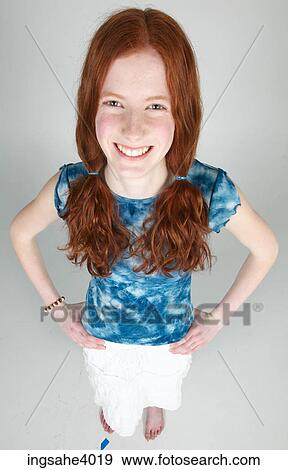 Stock Photo - Woman standing and smiling . Fotosearch