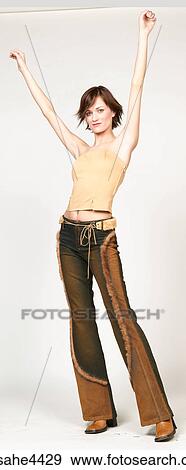 Woman stretching her arms into the air View Large Photo Image Stock Photo - Woman stretching her arms into the air. Fotosearch