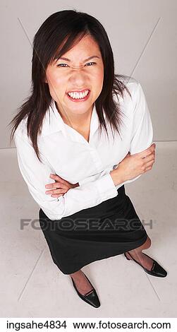 Young Asian business woman making a disgusted face View Large Photo Image Picture - Young Asian business woman making a disgusted face. Fotosearch