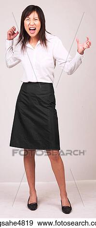 Young Asian business woman making a frustrated expression View Large Photo Image Stock Photo - Young Asian business woman making a frustrated expression. Fotosearch