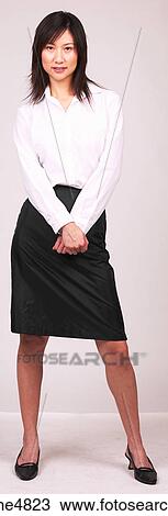 Young Asian business woman standing with her hands crossed in front of her View Large Photo Image Stock Image - Young Asian business woman standing with her hands crossed in front of her. Fotosearch