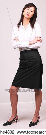 Young Asian business woman standing with her arms crossed in front of her View Large Photo Image Stock Image - Young Asian business woman standing with her arms crossed in front of her . Fotosearch