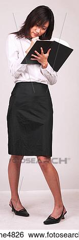 Young Asian business woman writing in a notebook View Large Photo Image Stock Photograph - Young Asian business woman writing in a notebook. Fotosearch