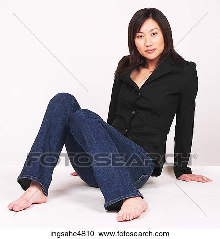 Young Asian woman sitting on the floor View Large Photo Image Stock Image - Young Asian woman sitting on the floor. Fotosearch