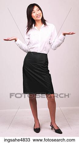 Young Asian woman standing with her hands out by her shoulders View Large Photo Image Stock Image - Young Asian woman standing with her hands out by her shoulders. Fotosearch