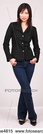 Young Asian woman standing with her hands in her pockets View Large Photo Image Stock Photography - Young Asian woman standing with her hands in her pockets . Fotosearch