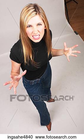 Young blond woman making an angry expression View Large Photo Image Stock Image - Young blond woman making an angry expression . Fotosearch
